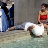 Tourists refresh themselves in the water of a fountain in downtown Rome in 2005 (Photo: VINCENZO PINTO/AFP via Getty Images)