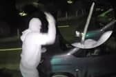Nathan Smith, 33, has been jailed for 5 years. Here he is smashing the windscreen of a vehicle, while wearing a balaclava, gloves and brandishing a machete.