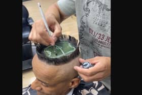 A hair artist created a miniature football stadium on a client's head.