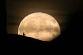 A Beaver Moon rises behind the Grade I listed St Michael's Tower on the top of Glastonbury Tor in 2017.