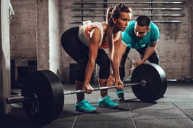 Woman exercising at the gym (Adobe stock)