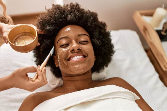 Woman having facial treatment at beauty center  (Adobe Stock)