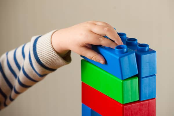 Child plays with building blocks.