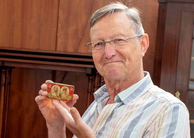 Adrian Kinton, from Hansons, holds the tiny tin of coronation chocolates