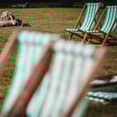 A man reads a book while sunbathing in Green Park in central London on September 5, 2023 as the country experiences a late heatwave. 