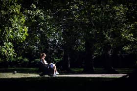 A woman reads a book on a bench in Green Park in central London on September 5, 2023 as the country experiences a late heatwave.