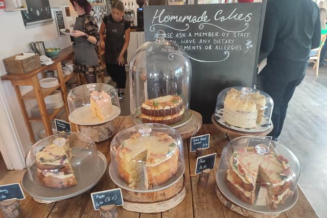 The packed cake counter filled with towering sponges is the first thing you see when you enter the cafe | Image Ria Ghei