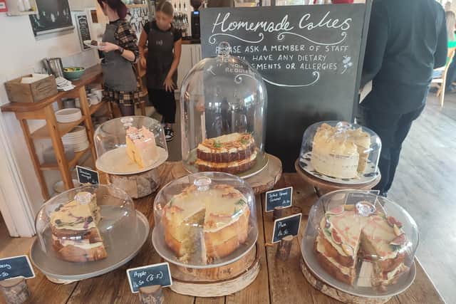 The packed cake counter filled with towering sponges is the first thing you see when you enter the cafe | Image Ria Ghei
