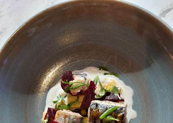 Confit potato and shimmering mackerel rolls rested in a punchy horseradish butter sauce | Image Ria Ghei