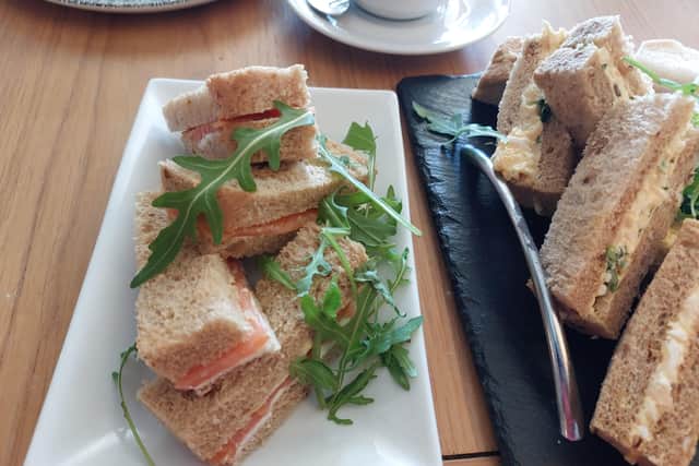 Salmon sandwiches with a few strands of rocket draped over | Image Ria Ghei