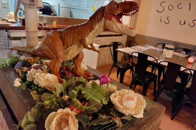 Bills are presented to diners at the end of the meal, tucked in the jaws of a dinosaur or toy model | Image Ria Ghei
