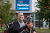 Karen Bishop, 51, with her 2-year-old French bull dog Drew outside the Travelodge in Norwich.