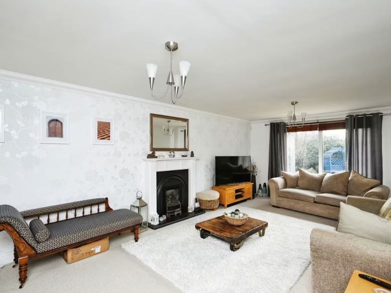 Light streams through large floor-to-ceiling windows in this Mickleover house