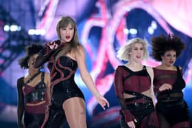 Taylor Swift onstage during the Eras Tour in her Reputation costume.