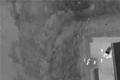 Suspects located by drone in dark undergrowth.