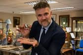 Lord Nelson's buckles will go under the hammer on November 28, 2024. Pictured is auctioneer Charles Hanson holding the buckles
