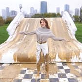 Binky Felstead encourages families to embrace the mud this half term as she's spotted going down a 2.5m high mudslide, created by Bosch at Mudchute Farm. 
