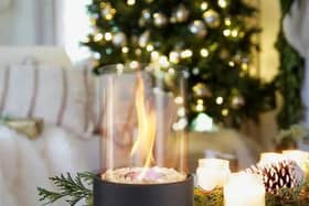The fireplace can sit in any room, giving off heat and setting a festive mood