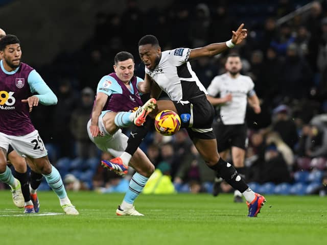 Derby County secured a point at promotion-chasing Burnley who were booed off at full-time