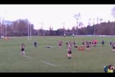 Video grab shows the moment a deer invaded a rugby pitch - and tackled a player. 