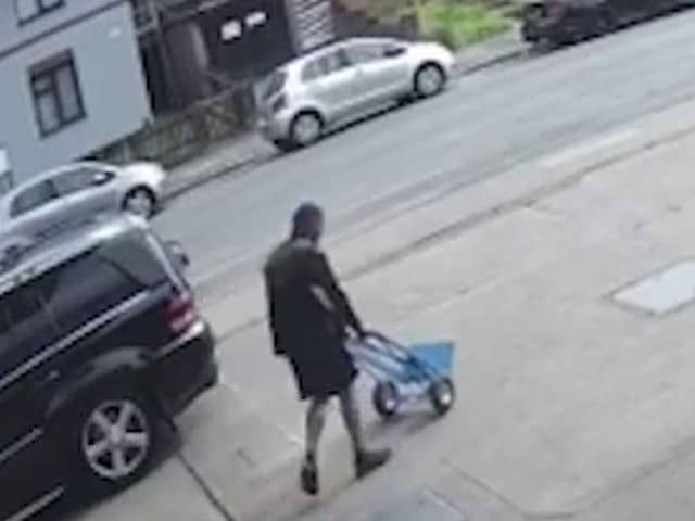 Sindeep Singh, wheeling a trolley home to transport his mother's body. 