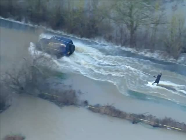 Man wakeboards along flooded road in Leicestershire.