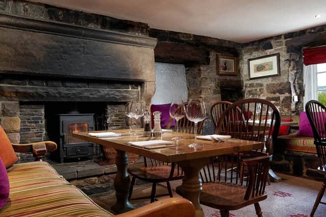 Dining by the cosy log fire at The Inn