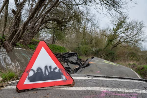 A road left so badly damaged by a landslip it was closed to cars can't be fixed properly - as it's still moving a YEAR later.  