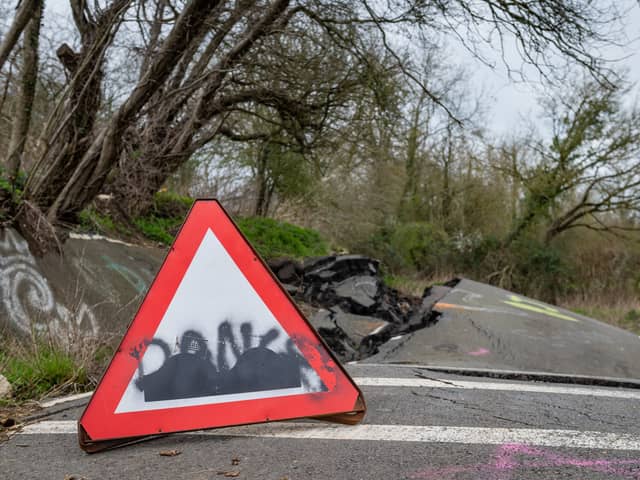 A road left so badly damaged by a landslip it was closed to cars can't be fixed properly - as it's still moving a YEAR later.  
