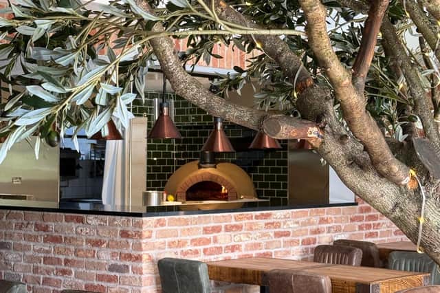 The 19th century lodge transformation includes a wood-fired pizza oven, elegant dining area and expansive windows streaming natural light to offer breath-taking views from the restaurant
