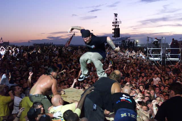 Fred Durst surfing the crowd at Woodstock 1999; the controversial performance became one of Trent Reznor's barbs against the nu-metal act during interviews.
