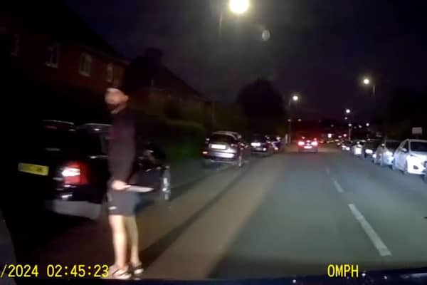 Murder victim drives away from his killer who is still grasping knife.