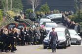 People pay their respects at the funeral of Slimming World founder Margaret Miles-Bramwell OBE as the cortege passes her company's head office before the service at Derby Cathedral.