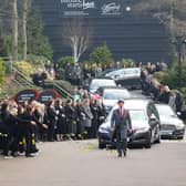 People pay their respects at the funeral of Slimming World founder Margaret Miles-Bramwell OBE as the cortege passes her company's head office before the service at Derby Cathedral.