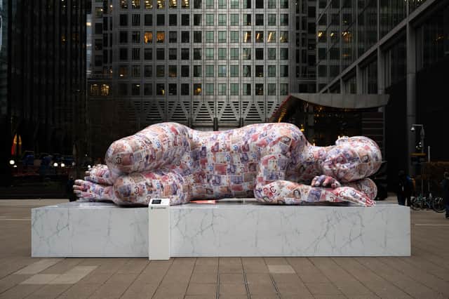The sculpture is covered in 2,000 fake bank notes