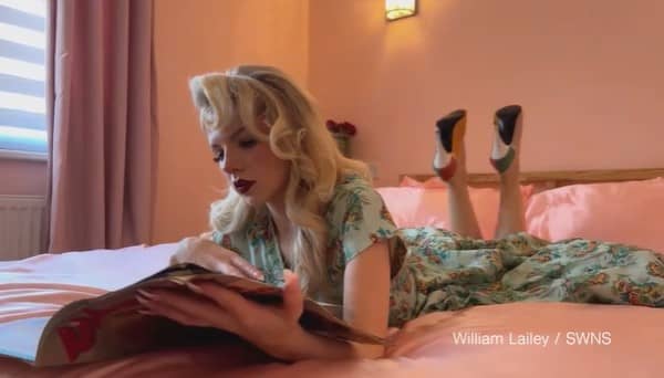 A vintage styled influencer reading a magazine on her bed