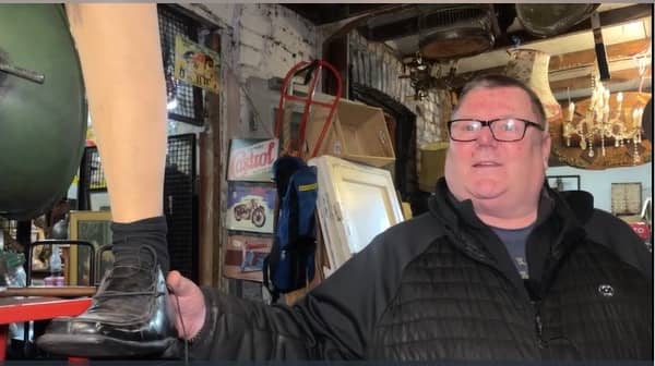 Shop owner holding an artificial leg
