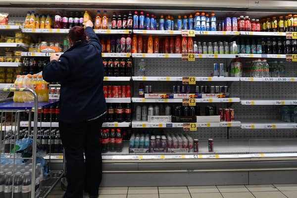 An employee stocks shelves at a Tesco supermarket in central London in 2021 (Photo: JUSTIN TALLIS/AFP via Getty Images)