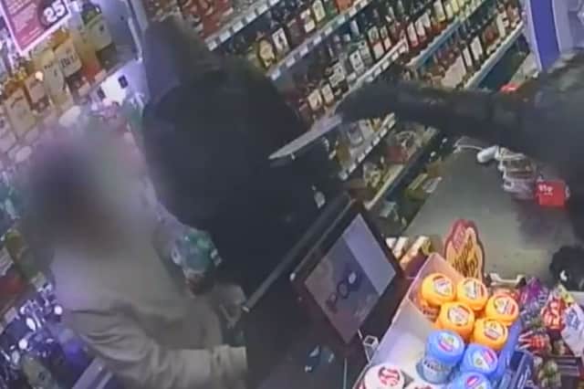 Shop owner is threatened with knife in Bolton.