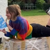 Author Charlotte Faulconbridge reading a book and smiling