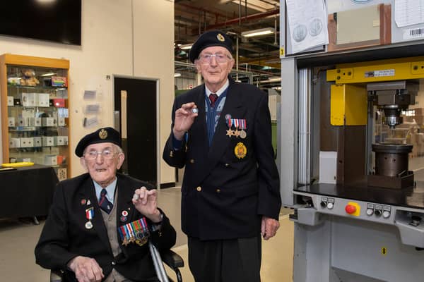 Veterans Richard Pelzer (left), 101, and Ron Horsey, 98, who both served with the Royal Engineers, holding the new VE Day 50p coin at the Royal Mint manufacturing site in South Wales (Photo: The Royal Mint)