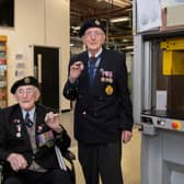 Veterans Richard Pelzer (left), 101, and Ron Horsey, 98, who both served with the Royal Engineers, holding the new VE Day 50p coin at the Royal Mint manufacturing site in South Wales (Photo: The Royal Mint)