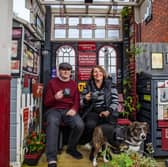 Train-mad couple Richard Cantrell and Katherine Siggins with dog Jess in the back garden at their home-made 'station'.