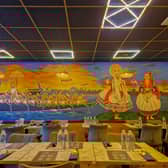 Aalappeaz is one of the newest eateries that has opened in Derby. Pictured is a shot from the interior showing South Indian artistry adorning the restaurant walls.