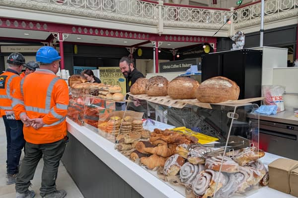 Ahead of the big Derby Market Hall launch, we chatted to traders and people behind the scenes. Pictured are workmen trying baked delights at Olivia's Coffee & Bakery on the ground floor.