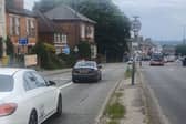 A screenshot from a video showing cars avoiding a road defect and getting close to the bus lane as a result. 