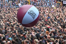 The Villa Park crowd plays with a huge beach ball as they watch support acts, during British rock band Black Sabbath's "Back to The Beginning" concert, Ozzy Osbourne's final ever gig as Black Sabbath's frontman at Villa Park in Birmingham