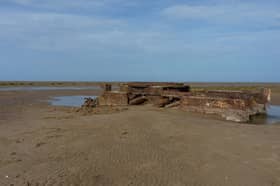 The remains of a tank on the beach at Saltfleetby