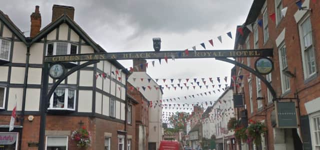 The Black's Head sculpture on the listed sign above St John's Street in Ashbourne before its removal
