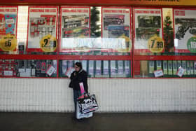 A woman waits outside a branch of Poundstretcher near Lewisham high street in London in 2012. The retailer is giving away free £10 vouchers to shoppers this weekend across the UK (Photo: Oli Scarff/Getty Images)